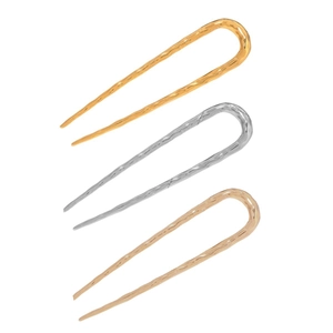 Detailed view of U-shaped metal hairpins with wave texture in gold, silver, and rose gold