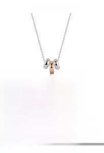 Detail of S925 sterling silver three-ring pendant in silver, gold and rose gold