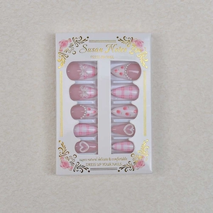 Flat lay of pink and white checkered press-on nails with 3D pearls and bow decorations