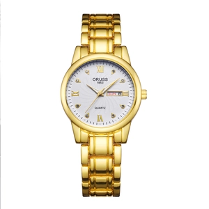 Detailed macro view of ORUSS gold watch face with roman numerals and day-date display