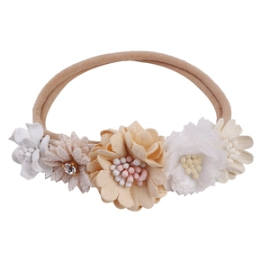 Detail of baby floral headband featuring chiffon flowers and a sparkling rhinestone