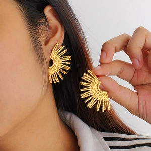 18K gold plated stainless steel fan earrings with hammered texture on female model