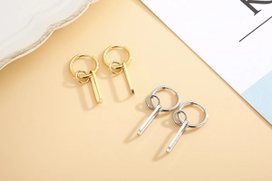 Detail view of multi-layer round hoop earrings with golden and silver finishes