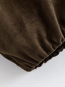 Macro shot of dark brown faux suede texture with elastic pleated cuffs detail