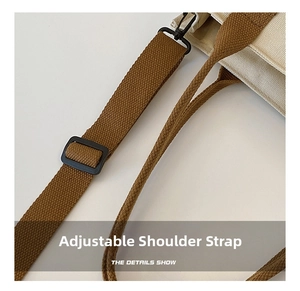 Detail of adjustable woven shoulder strap with black plastic buckle for canvas bag