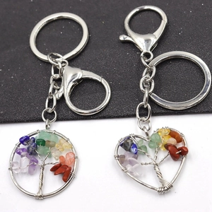 Detail of round and heart tree of life pendants with colorful chakra crystal stones
