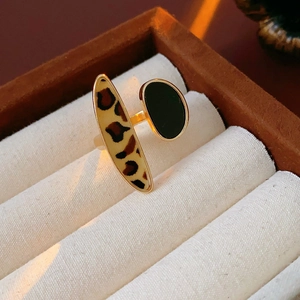 Close-up of golden adjustable ring with leopard print and dark oval enamel inlay