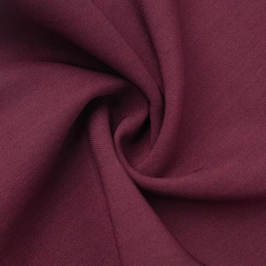 Macro shot of burgundy fine knit fabric with professional rib texture and silky drape