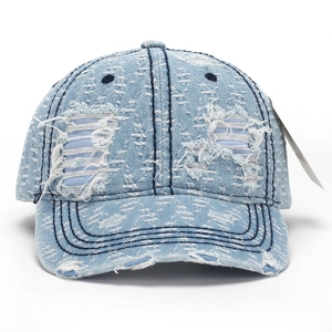 Distressed light blue denim baseball cap with vintage rips and herringbone texture