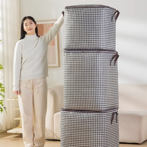Large houndstooth fabric storage bags with reinforced handles shown in a home setting