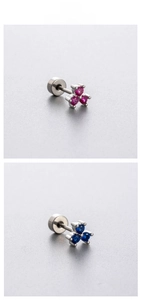 Macro shot of titanium steel flower screw-back earrings with pink and blue zircons