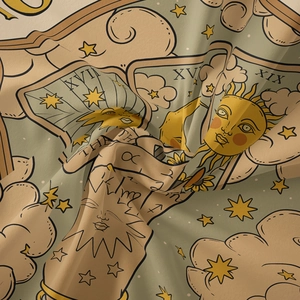 Macro detail of Bohemian tapestry fabric showing Sun Moon and Star tarot card patterns
