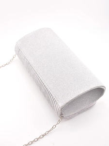 Detailed view of silver clutch bag featuring pleated texture and fine glitter fabric finish