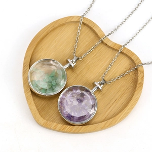Polished round natural crystal pendant necklace set with green and purple stones