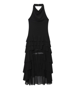 Detail of black halter neck dress featuring layered ruffles and asymmetric hemline