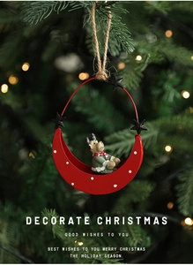 Close-up of a Christmas moon pendant featuring a reindeer in a festive bokeh background