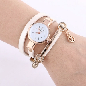 Detail showing white PU leather wrap strap and rose gold watch dial on a wrist