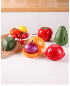 Detail view of tomato and onion shaped plastic food storage boxes on a kitchen counter