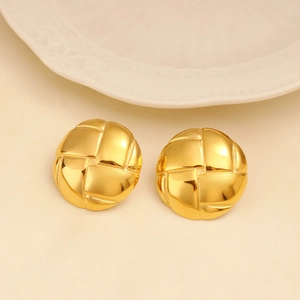 Detailed close-up of golden circular stud earrings featuring a textured woven mesh pattern