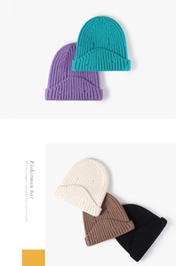 Close-up detail of knitted beanie hats featuring distressed ripped textures and ribbed cuffs