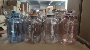 Group of gradient plastic sports water bottles with straw and handle in original packaging