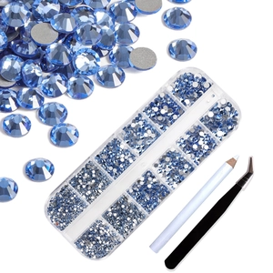 Detailed set of blue flatback nail art rhinestones with storage box, pen, and tweezers