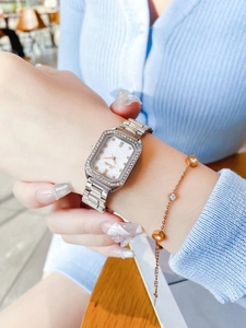 Elegant silver square watch with diamond bezel paired with a dainty gold bracelet