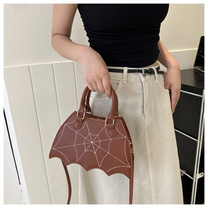 Gothic bat-shaped handbag in brown faux leather featuring white spider web embroidery