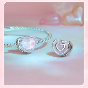 Detalle de pulsera de plata S925 con colgante de corazón rosa esmaltado y circonitas brillantes