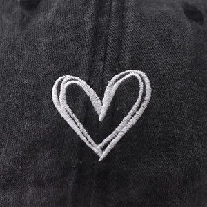 Washed vintage cotton baseball cap featuring minimalist white heart embroidery detail