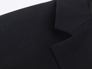 Detailed macro view of the black lace suit dress lapel and shoulder stitching details