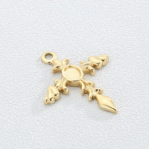 Golden titanium steel cross pendant with vintage patterns on white texture