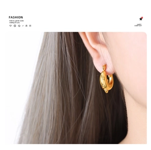 Close-up of 18k gold plated hollow teardrop earrings showing polished metal texture