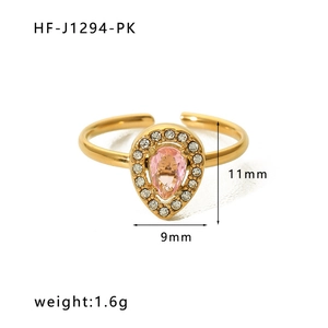Detail view of pear-cut pink gemstone ring with zircon halo and gold adjustable band