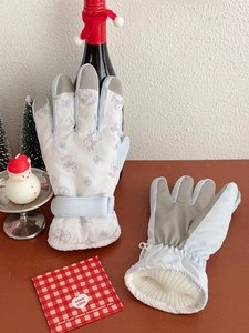 Detail of waterproof ski gloves featuring a cute bunny print and non-slip palm patches