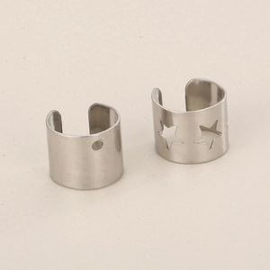 Detailed shot of silver star cutout ear cuff and minimalist round hole clip design
