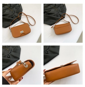 Detail view of brown faux leather crossbody bag with silver twist lock and chain