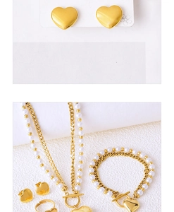 Detail of a golden heart jewelry set with white pearls including earrings and necklaces
