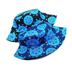 Detail of canvas bucket hats featuring blue Turkish Evil Eye and Mandala patterns