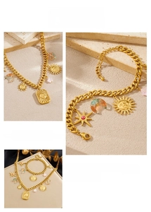 Macro detail of gold celestial jewelry set with sun motifs and gradient moon charms