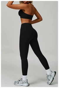 Detail view of black cross-back sports bra and high-waist yoga leggings set for women