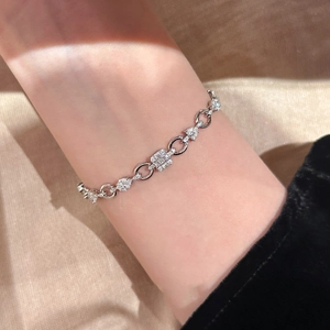 Macro shot of Zircon rectangular OT bracelet on wrist with elegant silver finish