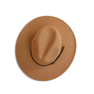 Top view of a camel fedora hat featuring a wide brim and dark brown leather buckle band