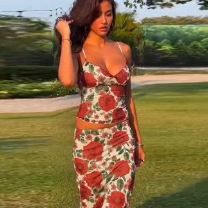 Detail of floral V-neck camisole and bodycon long skirt set with red rose patterns
