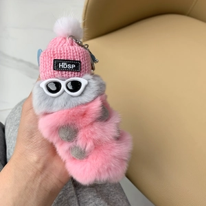 Detail of pink and gray plush caterpillar keychain with pink knit hat and sunglasses