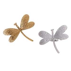 Golden and silver stainless steel dragonfly open rings with textured wings on white backdrop
