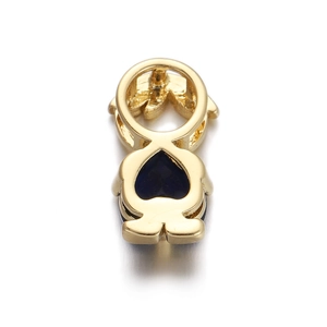 Macro shot of gold boy-shaped charm with blue heart-shaped zircon for jewelry making