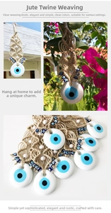 Detail of handmade evil eye macrame wall hanging with blue beads and woven twine rope