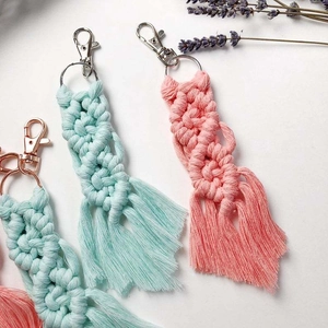 Detail of bohemian macramé keychain with handmade cotton weave and metal lobster clasp