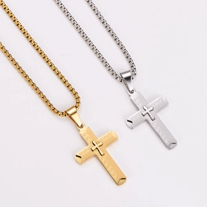 Three-dimensional cross necklace in gold and silver finish with textured patterns